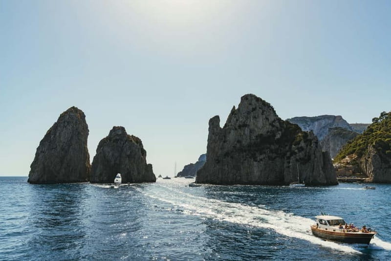 From Sorrento: Capri Boat Cruise with Swimming and Prosecco - Leaving Sorrento on the water, with Punta Campanella in the background